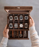 A person holding a Bayswater 8 Slot Watch Box with Drawer - Brown by TAWBURY.