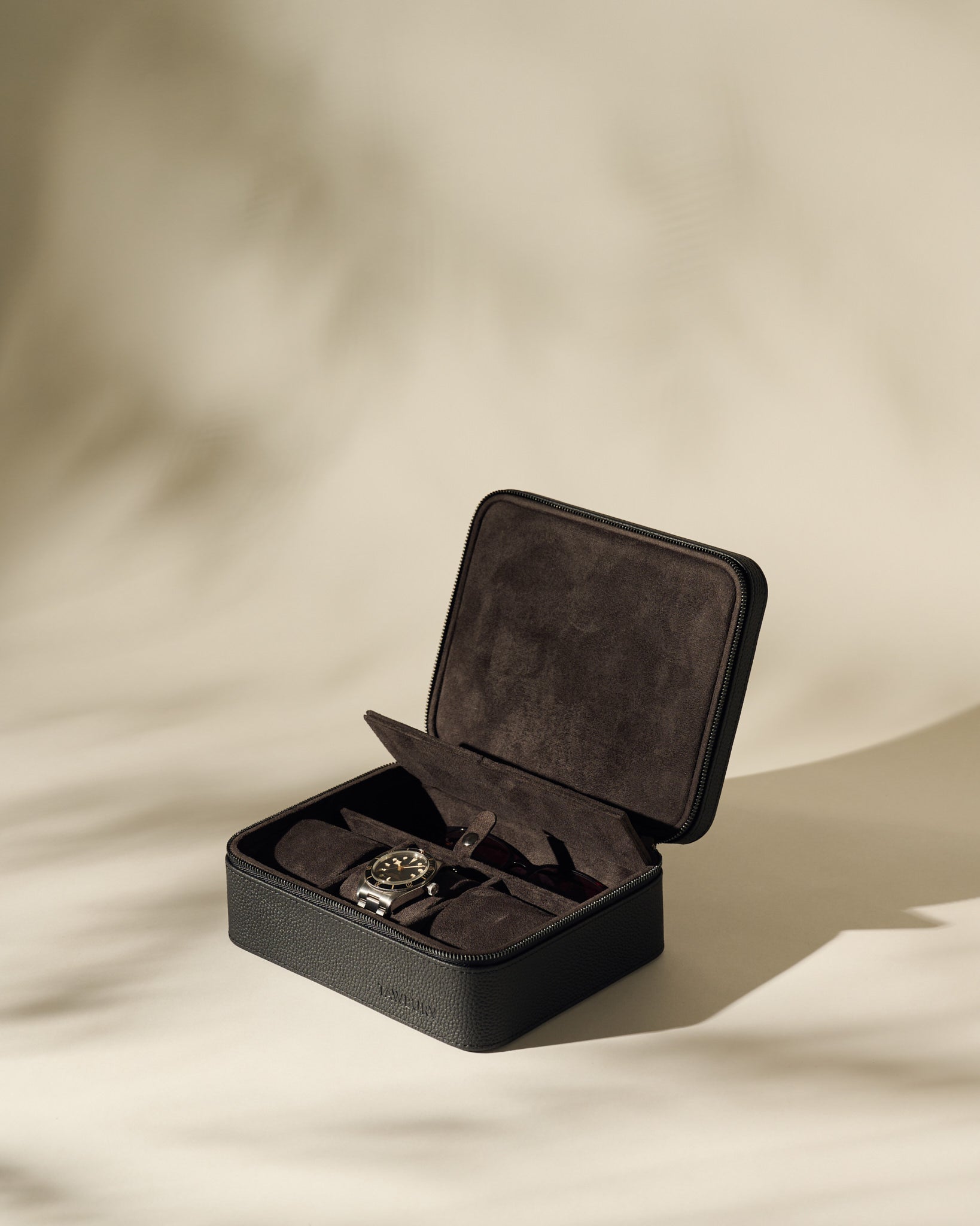 The TAWBURY Fraser 3 Watch Case with Storage in black is open, displaying elegant space for three wristwatches against a neutral background.
