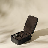 The TAWBURY Fraser 4 Watch Case - Black features a sleek leather exterior and suede-like interior, securely holding up to four watches—an ideal travel case for your collection.