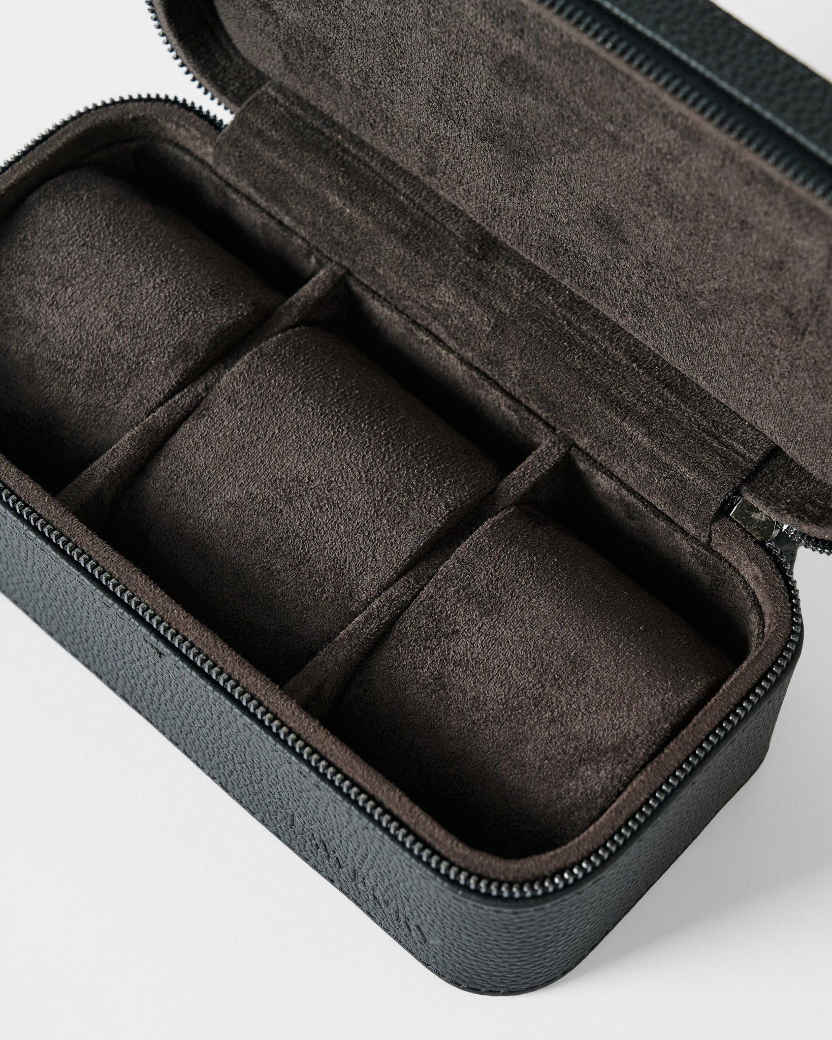 The TAWBURY Fraser 3 Watch Case - Black features three padded compartments and dark soft lining in a sleek zippered leather design—perfect for elegant watch storage at home or while traveling.