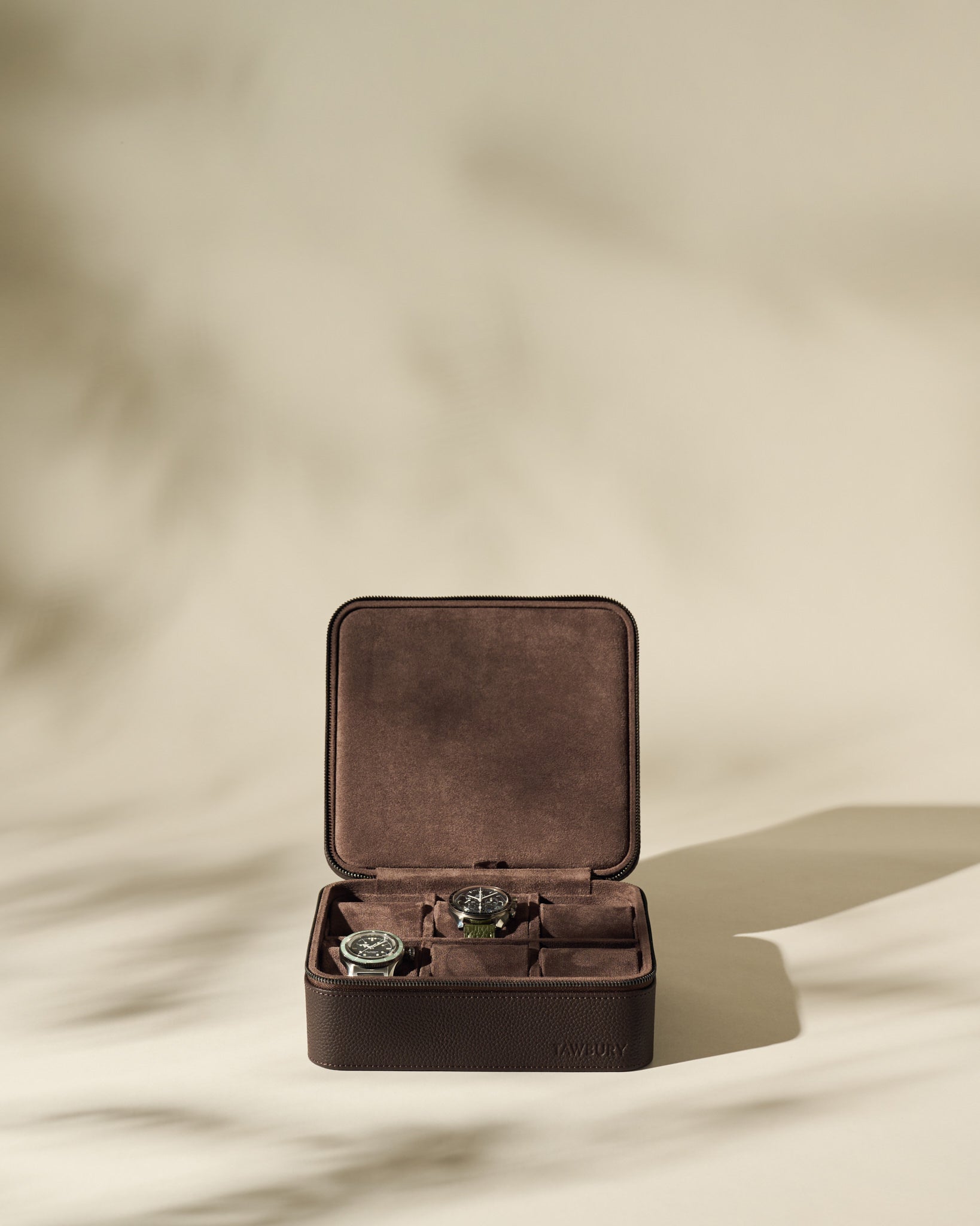 The TAWBURY Fraser 6 Watch Case - Brown offers elegant storage and style for your favorite timepieces, securely displaying up to six watches in a luxurious leather case with a refined, neutral look.
