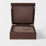 The TAWBURY Grove 12 Slot Wooden Watch Box in dark walnut wood features a closed lid and velvet-lined compartments, perfect for storing watches or jewelry.