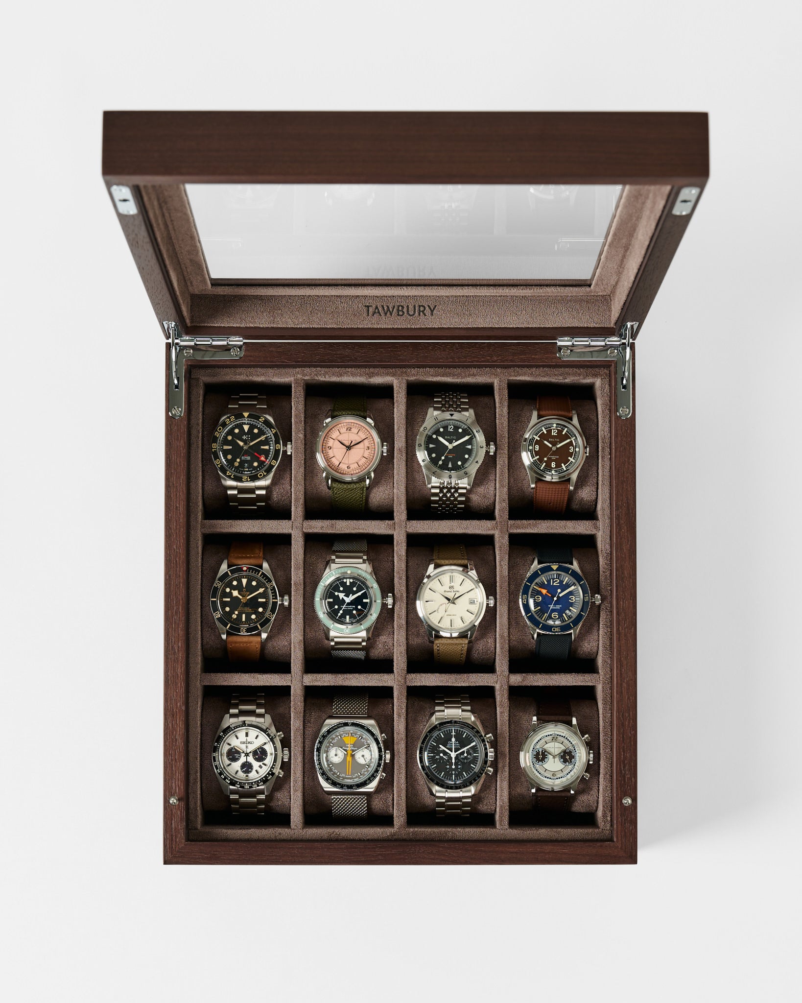 The TAWBURY Grove 12 Slot Wooden Watch Box in dark walnut features a glass lid and displays twelve wristwatches in individual compartments—perfect for collectors and shown from a top-down view.