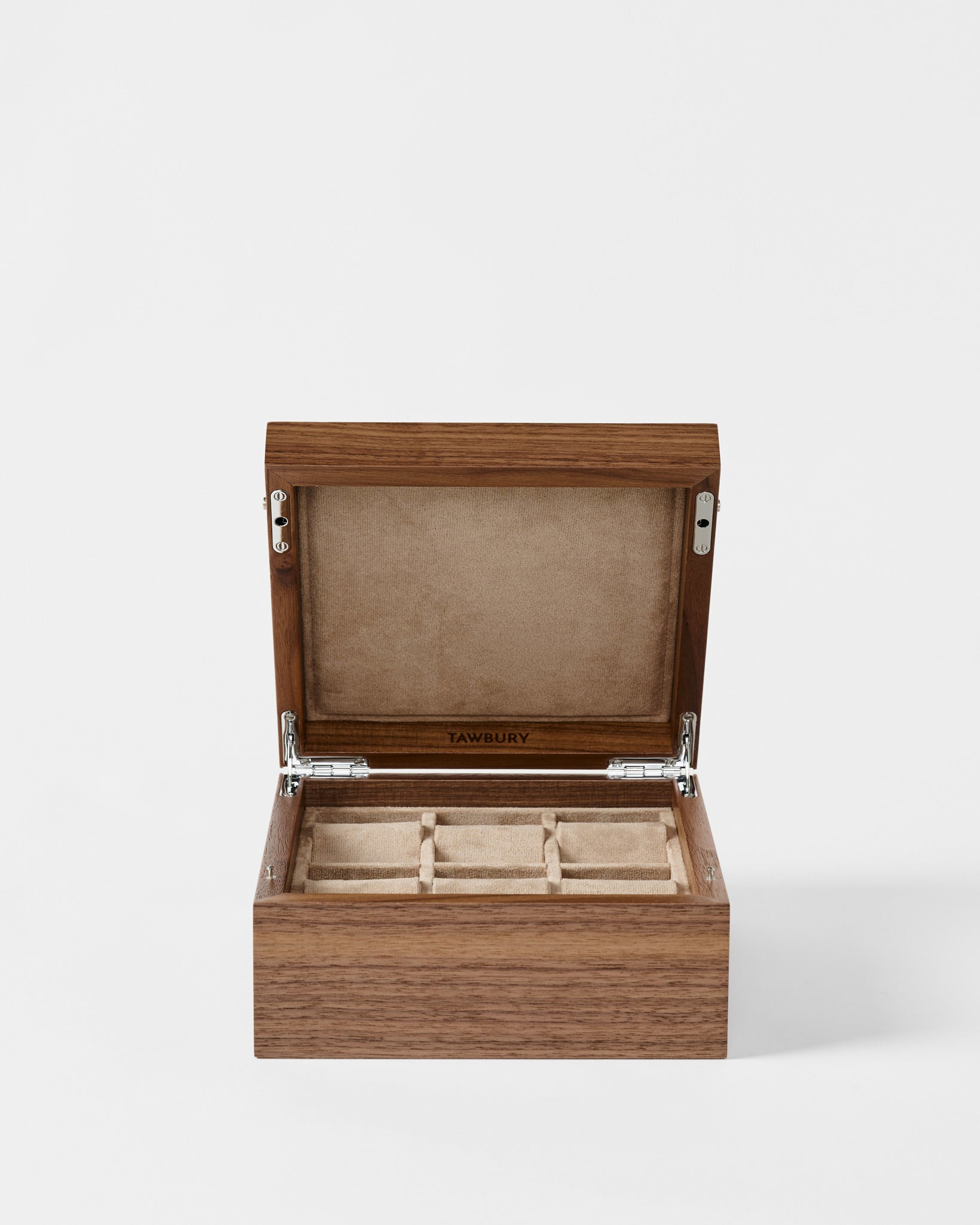 The TAWBURY Grove 6 Slot Wooden Watch Box in Light Walnut features a solid lid and beige suede-lined interior with individual compartments—an elegant solution for displaying and storing your watches.