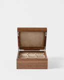 The TAWBURY Grove 6 Slot Wooden Watch Box in Light Walnut features a solid lid and beige suede-lined interior with individual compartments—an elegant solution for displaying and storing your watches.