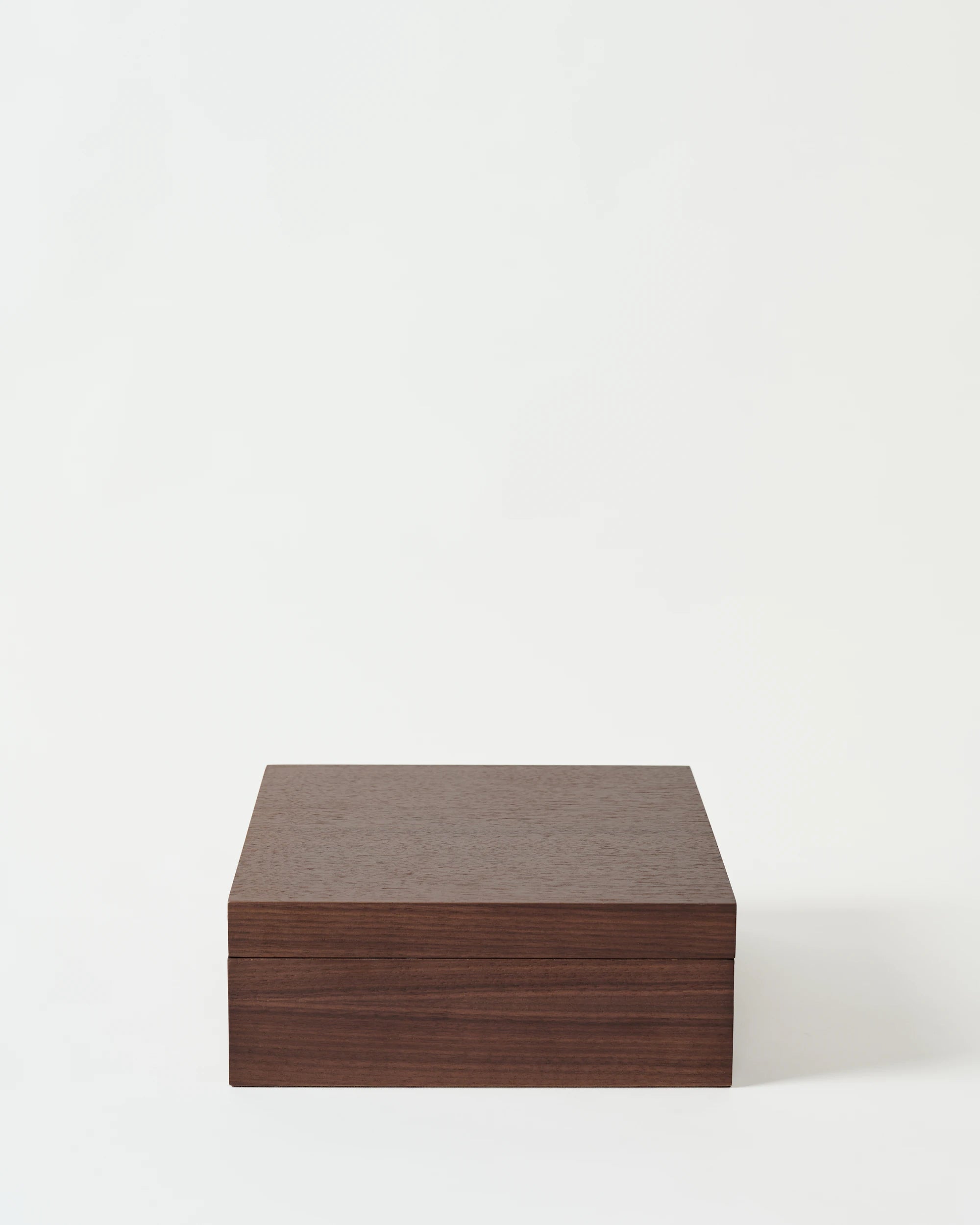 The TAWBURY Grove 12 Slot Wooden Watch Box features a solid lid and dark walnut finish, displayed against a plain white background.