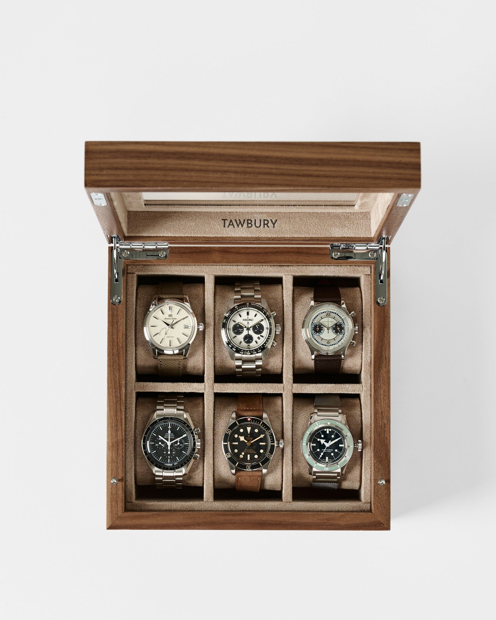 A must-have for watch lovers, the TAWBURY Grove 6 Slot Wooden Watch Box in Light Walnut features a glass lid and six compartments to stylishly display your wristwatch collection.