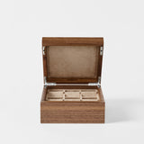 The TAWBURY Grove 6 Slot Wooden Watch Box in classic walnut features six velvet-lined compartments, perfect for organizing your collection while keeping it protected with a closed lid.