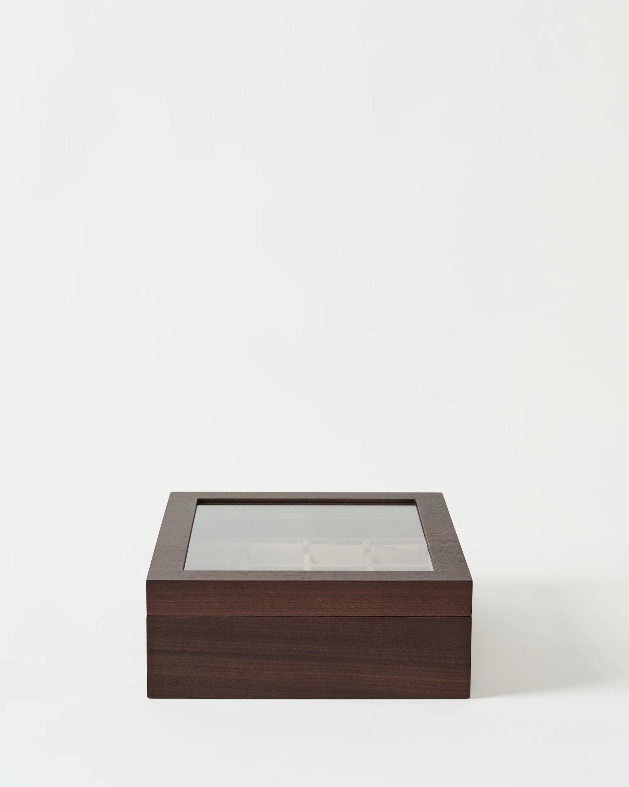 The TAWBURY Grove 12 Slot Wooden Watch Box in dark walnut with a glass lid is displayed on a plain white background.