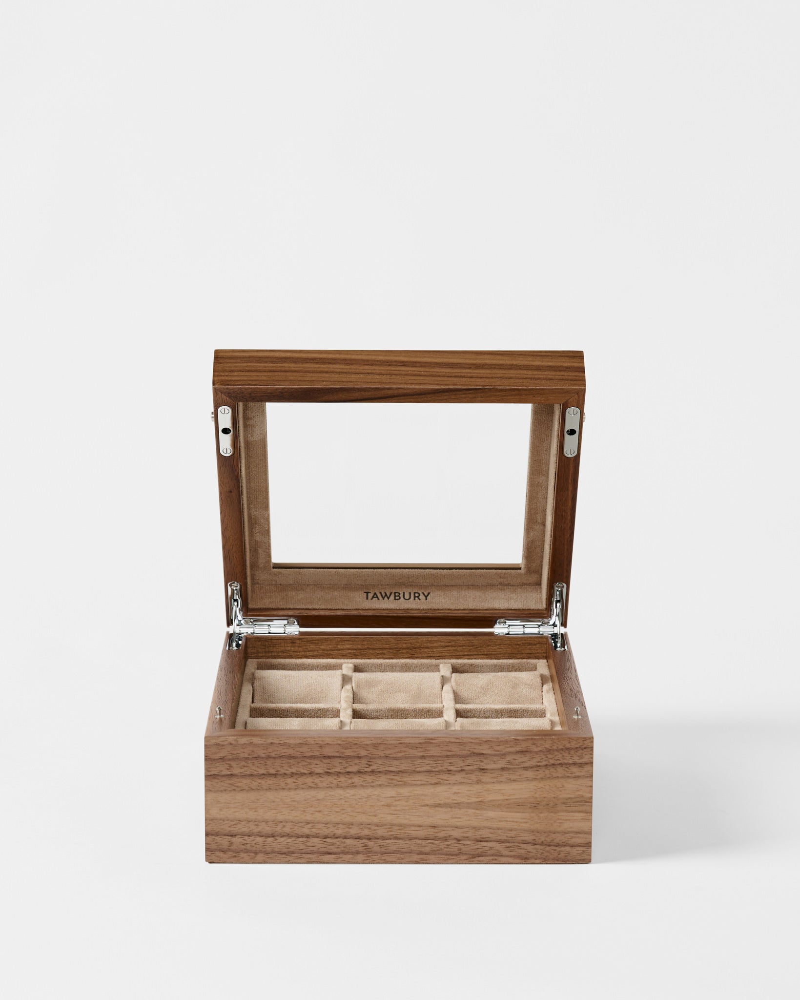 The TAWBURY Grove 6 Slot Wooden Watch Box in Light Walnut features a glass lid, beige interior, and six compartments—perfect for watch lovers. Shown open against a plain white background.