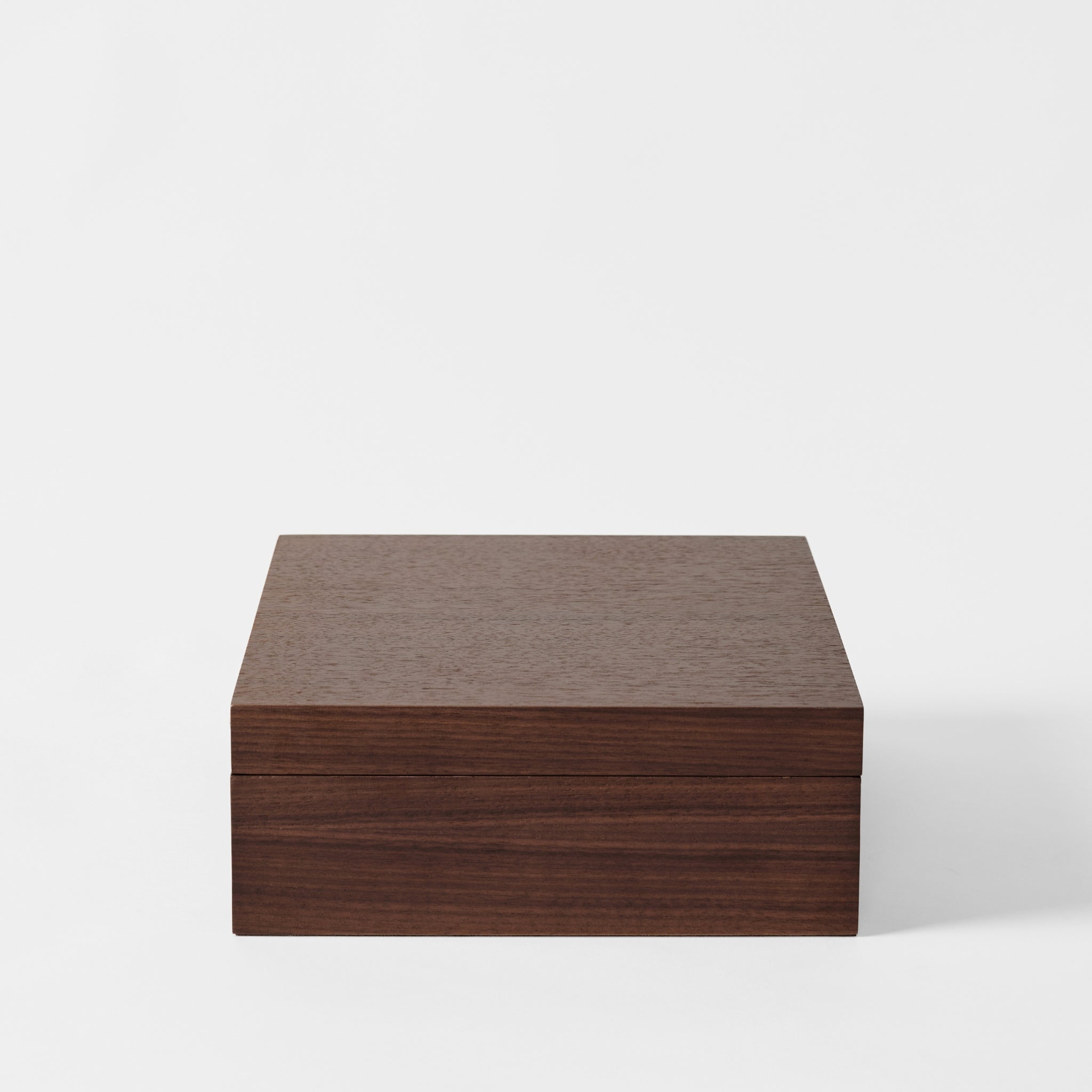 The TAWBURY Grove 12 Slot Wooden Watch Box features a closed lid and a smooth, dark walnut wood finish, displayed against a plain white background.