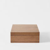 The TAWBURY Grove 12 Slot Wooden Watch Box in classic walnut wood features a closed lid and smooth finish, perfect for stylish watch storage on any plain white background.
