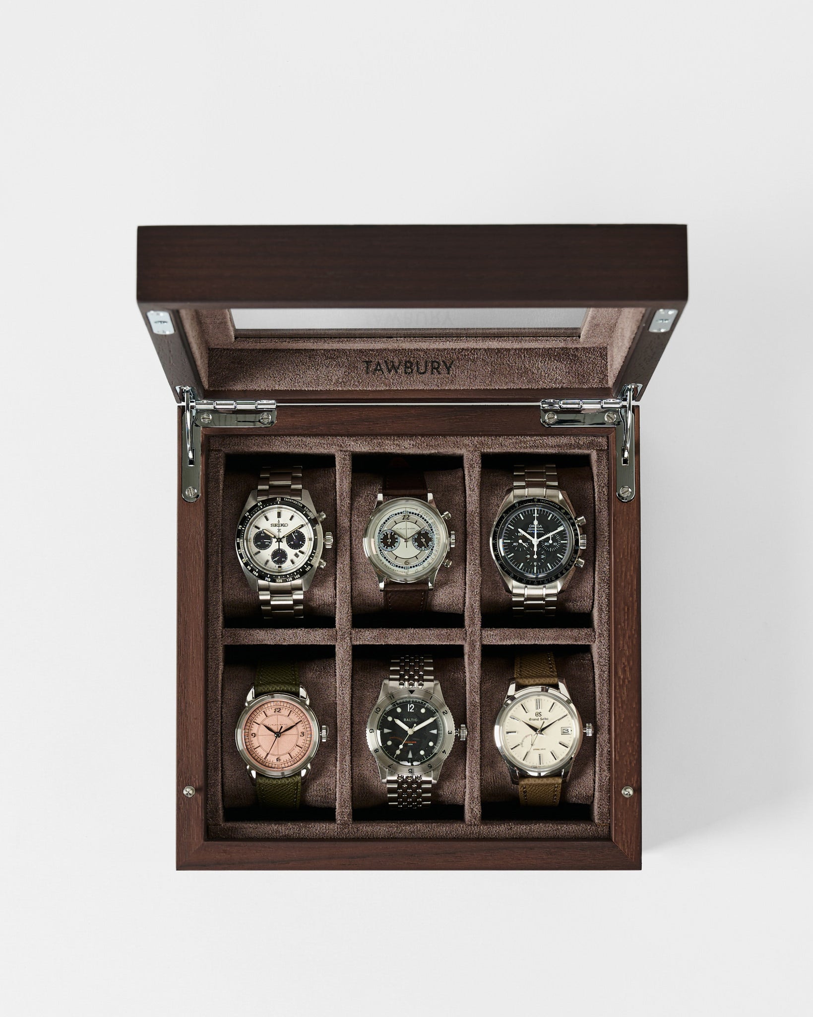 The TAWBURY Grove 6 Slot Wooden Watch Box in dark walnut features a glass lid and six cushioned compartments for neatly organizing your wristwatches in style.