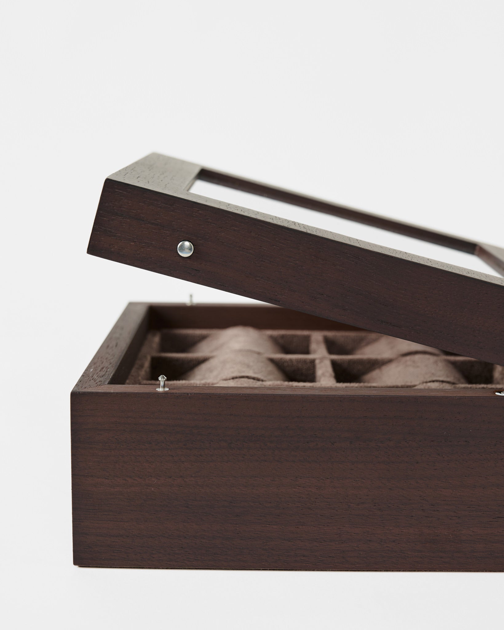 The TAWBURY Grove 6 Slot Wooden Watch Box in dark walnut features a glass lid partially open to reveal divided compartments—ideal for organizing your collection. Photographed against a white background.