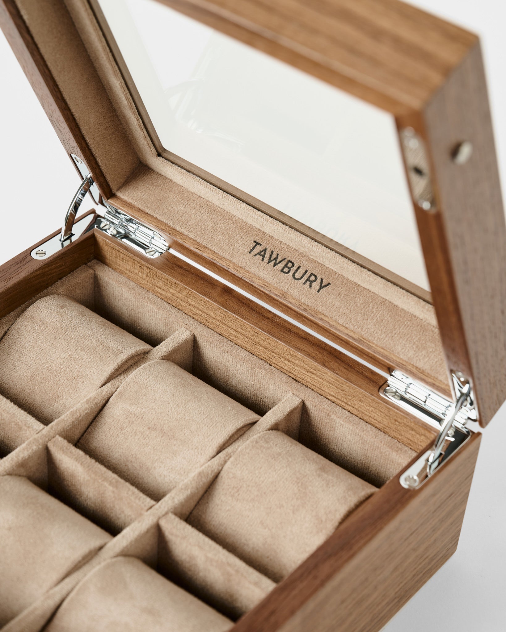 Open Grove 6 Slot Wooden Watch Box by TAWBURY in light walnut wood, with a glass lid and six beige velvet-lined compartments—an elegant choice for watch enthusiasts seeking stylish wooden storage.
