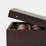 The TAWBURY Grove 6 Slot Wooden Watch Box in dark walnut wood features a solid, hinged lid partially open to reveal its brown fabric-lined, compartmentalized interior.
