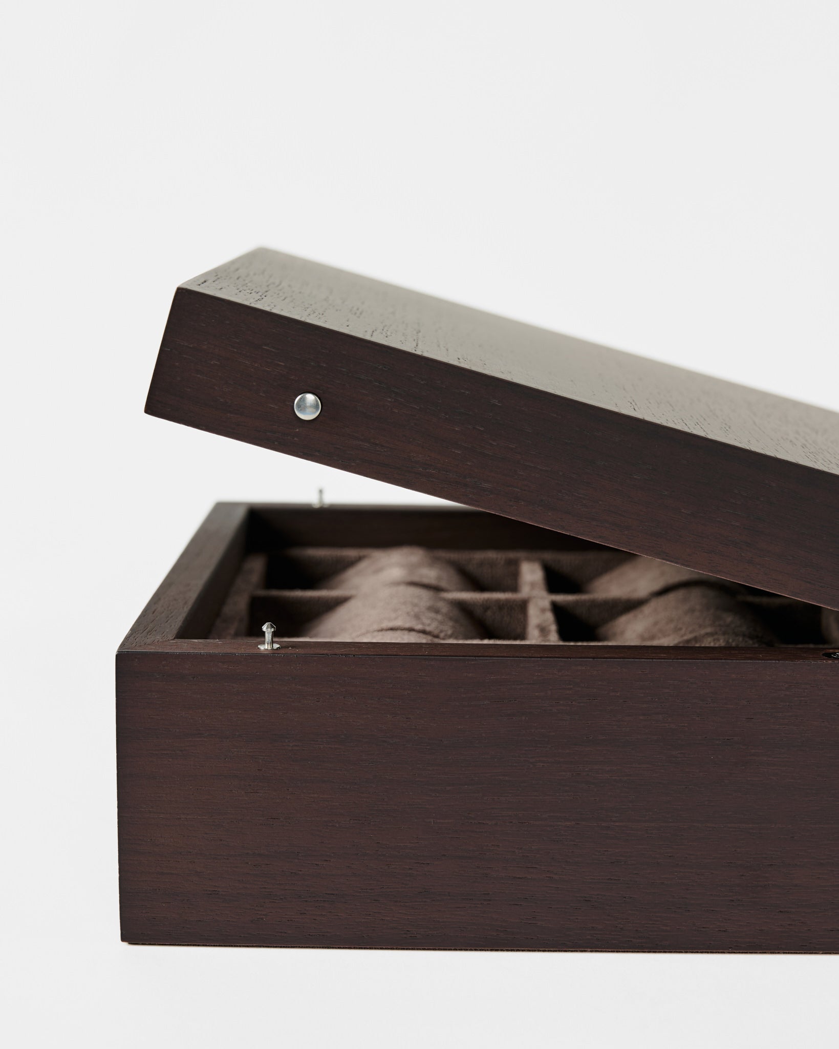 The TAWBURY Grove 6 Slot Wooden Watch Box in dark walnut wood features a solid, hinged lid partially open to reveal its brown fabric-lined, compartmentalized interior.