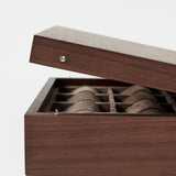 The TAWBURY Grove 12 Slot Wooden Watch Box in dark walnut wood, featuring a solid lid, elegantly displays multiple compartments for watch storage against a plain white background.
