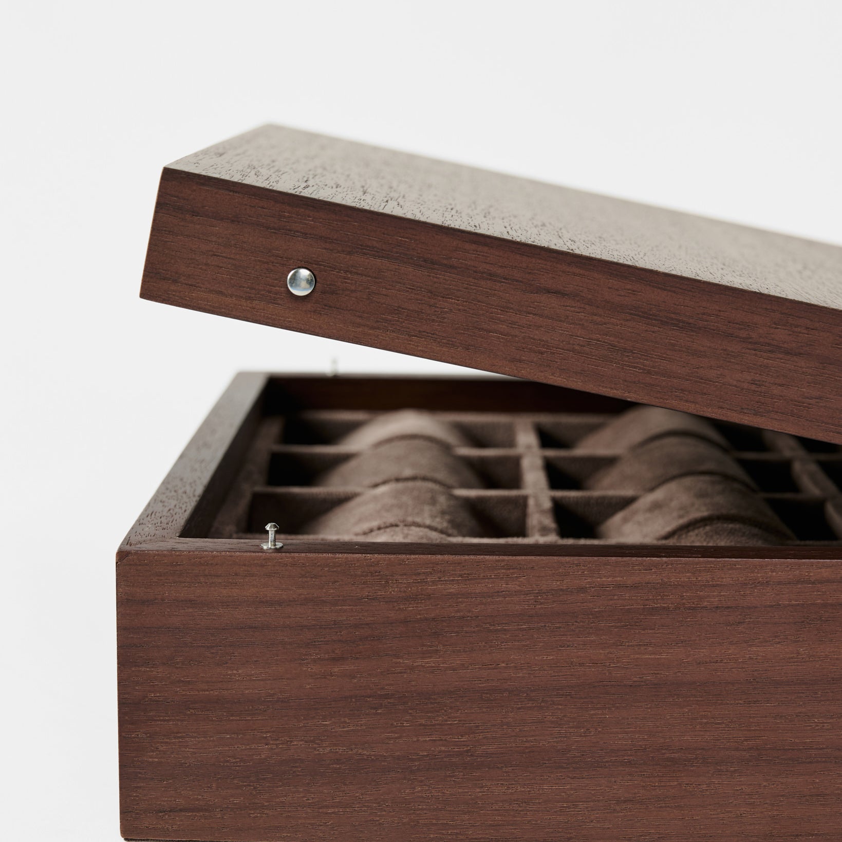 The TAWBURY Grove 12 Slot Wooden Watch Box in dark walnut wood, featuring a solid lid, elegantly displays multiple compartments for watch storage against a plain white background.
