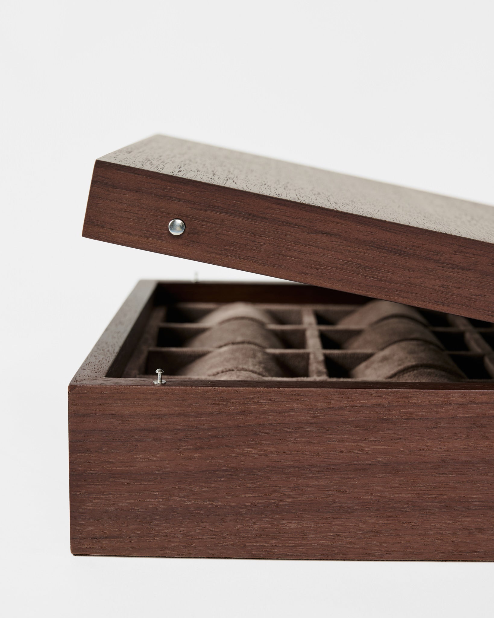 The TAWBURY Grove 12 Slot Wooden Watch Box in dark walnut wood, featuring a solid lid, elegantly displays multiple compartments for watch storage against a plain white background.
