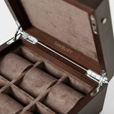 The Grove 6 Slot Wooden Watch Box by TAWBURY features a dark walnut wood exterior, solid lid, soft brown interior with multiple compartments, and “TAWBURY” engraved inside the lid.