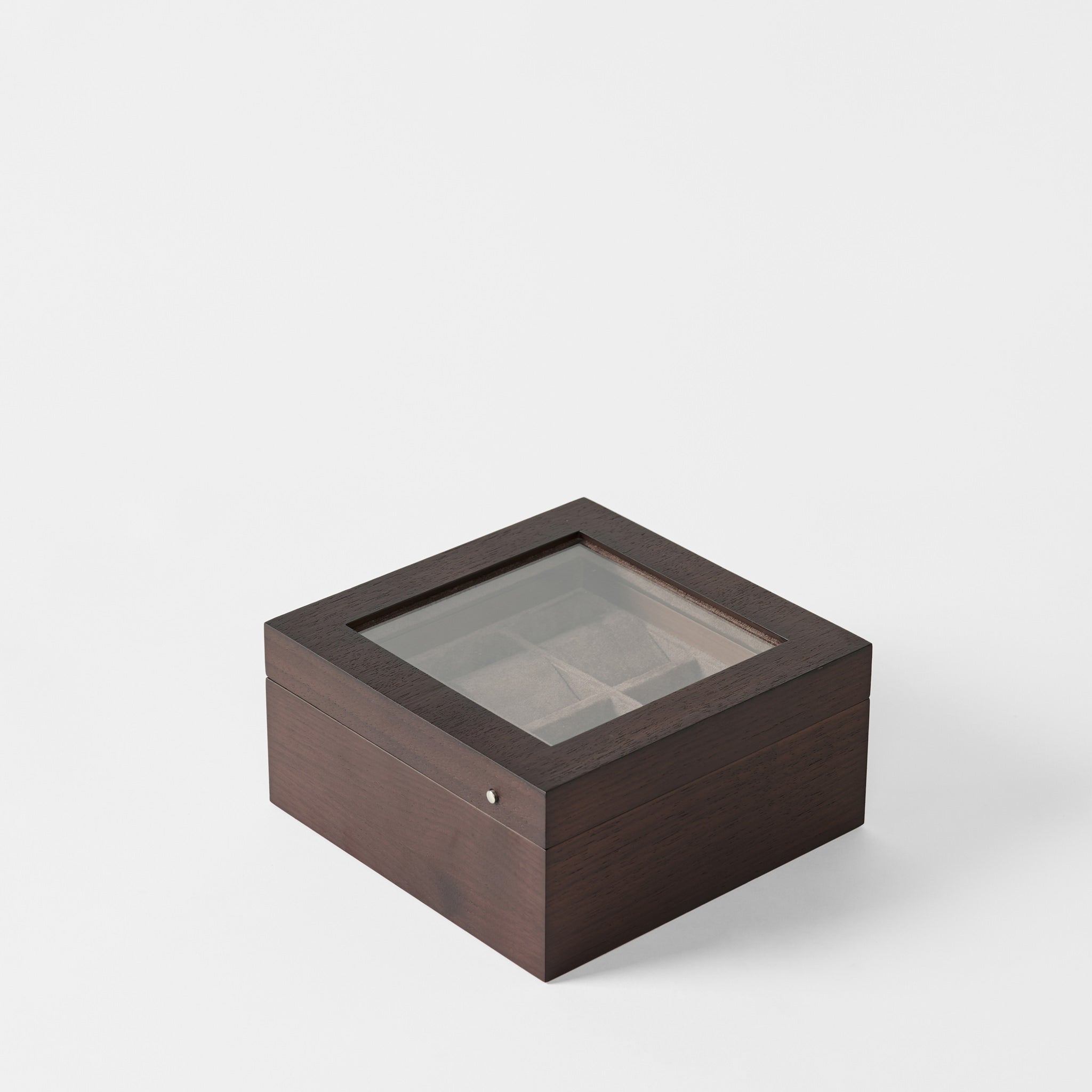 The TAWBURY Grove 6 Slot Wooden Watch Box in Dark Walnut features a glass lid and padded compartments, making it an elegant display case for watches, shown against a white background.