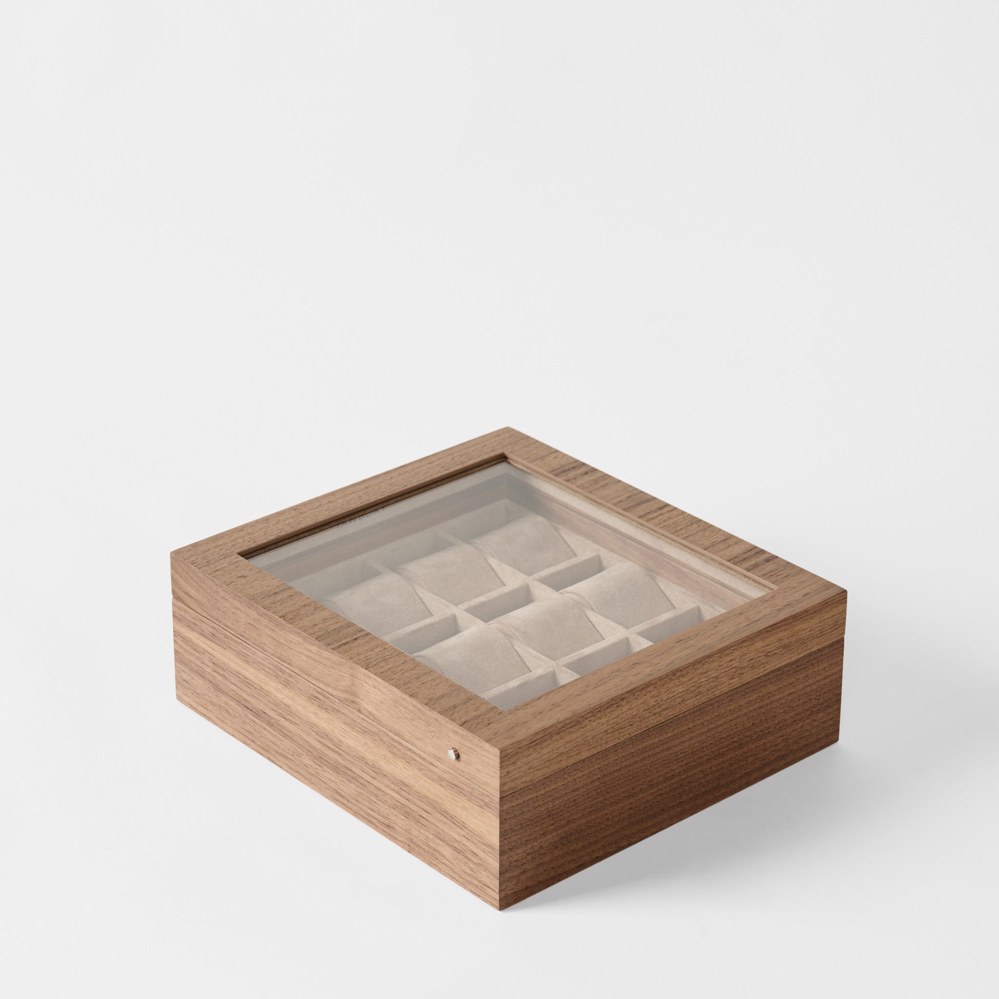 The TAWBURY Grove 12 Slot Wooden Watch Box in classic walnut wood features a glass lid and interior compartments, elegantly organizing multiple watches and showcased on a white background.