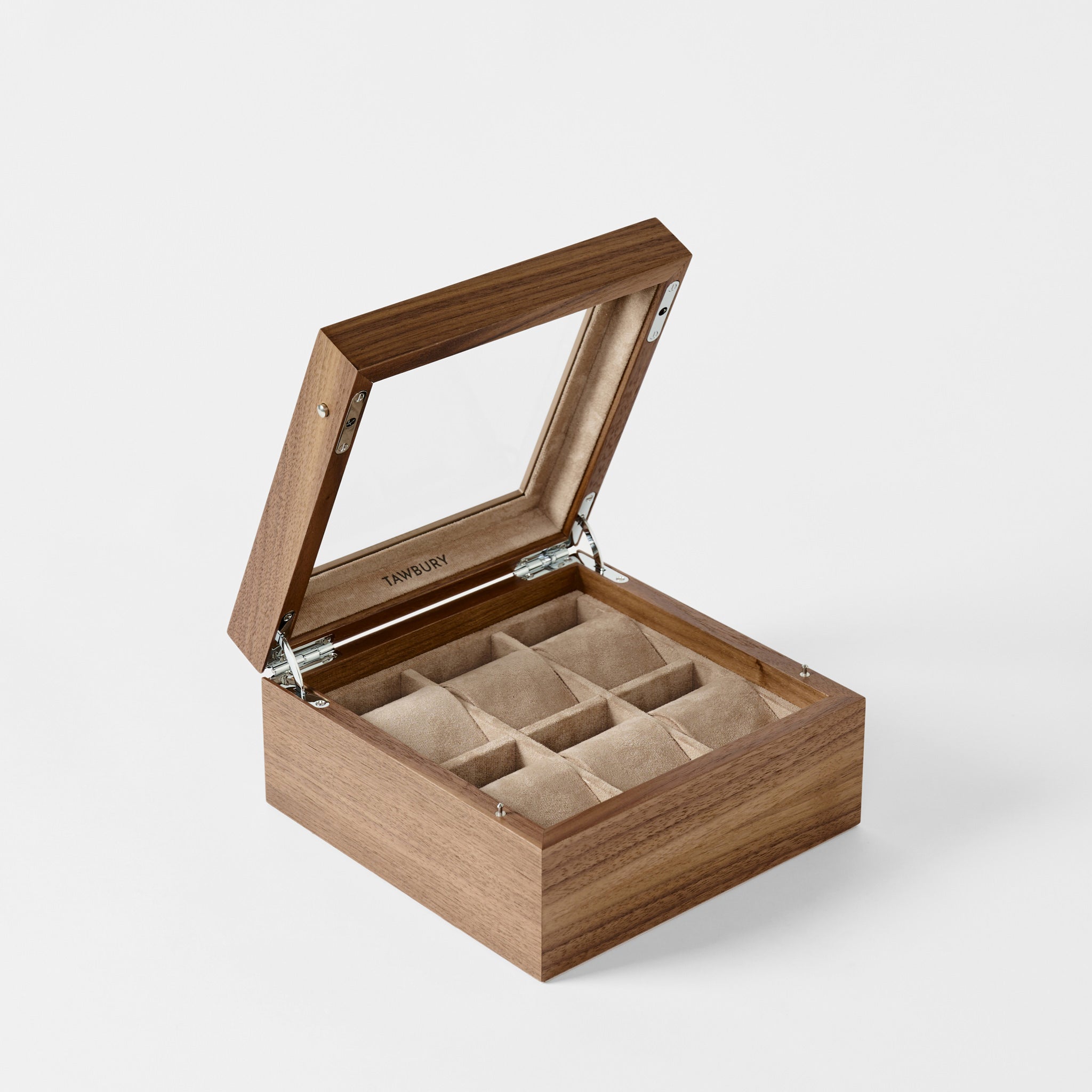 The TAWBURY Grove 6 Slot Wooden Watch Box in classic walnut features a glass lid and six cushioned, beige-lined compartments—an elegant way to organize and display your watch collection.