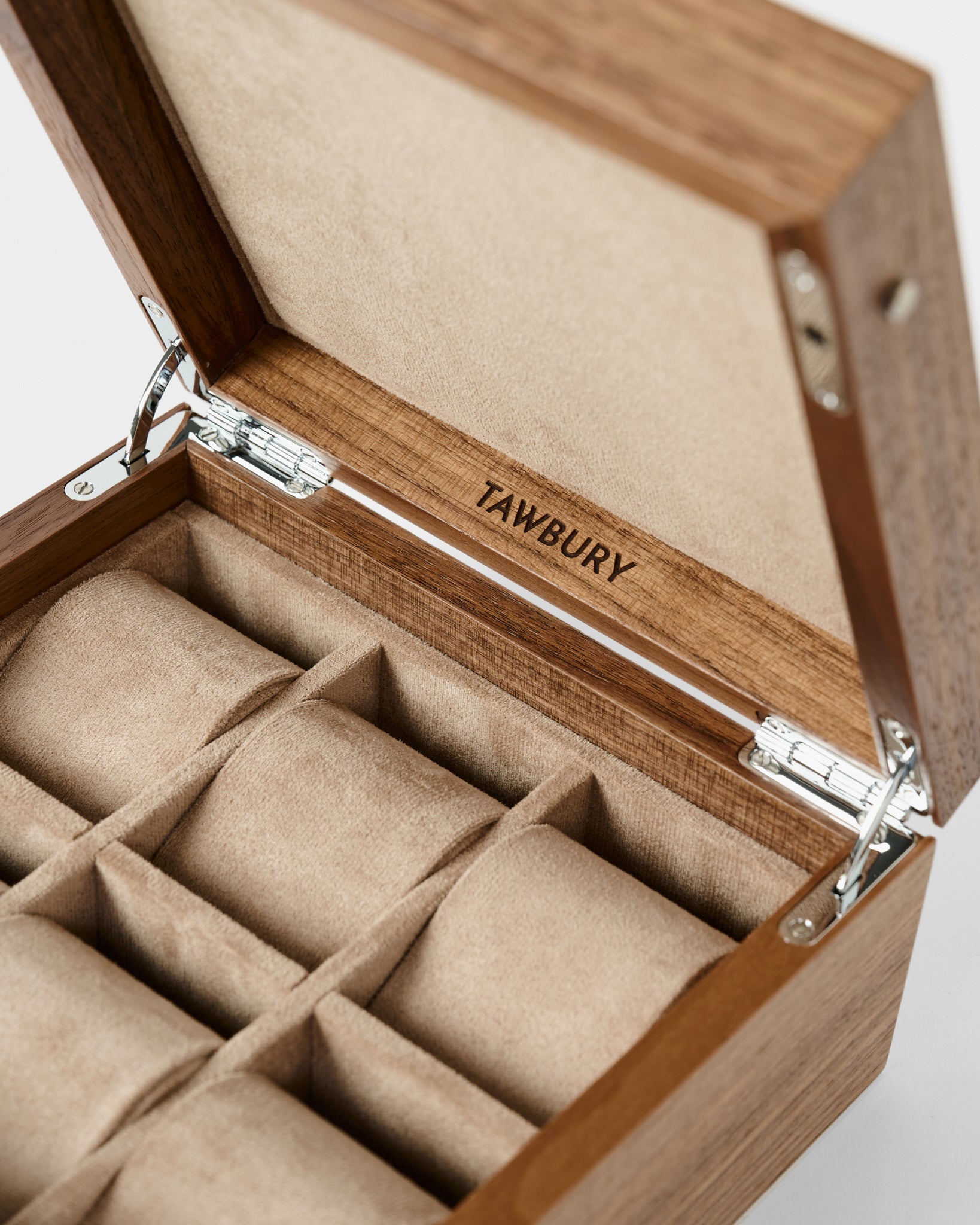 The TAWBURY Grove 6 Slot Wooden Watch Box in light walnut features a solid lid and six cushioned compartments, ideal for stylishly displaying your watch collection.