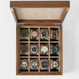 The TAWBURY Grove 12 Slot Wooden Watch Box in light walnut offers elegant storage for twelve watches, each in its own compartment, and features a solid lid for secure and stylish organization.